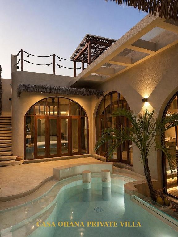 a house with a swimming pool in front of it at CASA Ohana Private Villa in Thai Muang