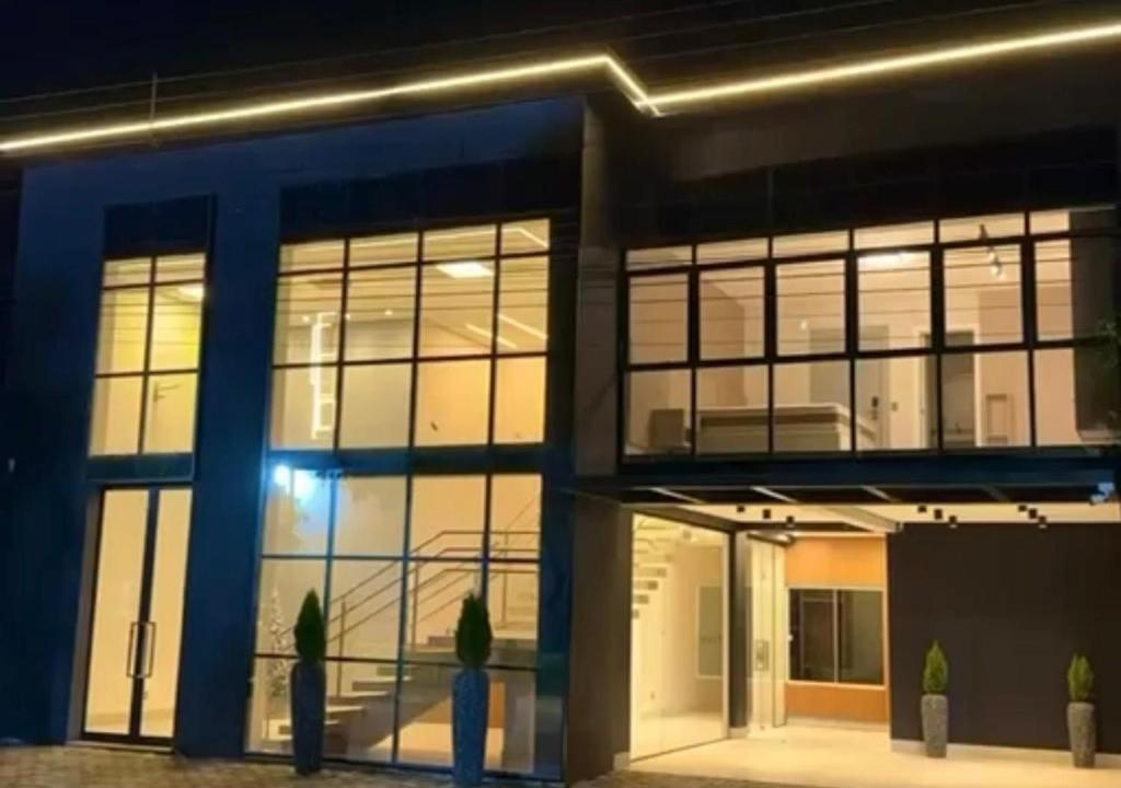 a large building with large windows at night at Hotel El Shaddai in Pontes e Lacerda