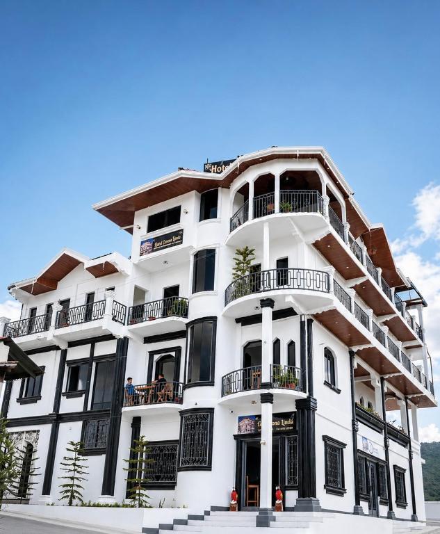 a white building with balconies on the side of it at Hotel Loma Linda in Ocotal