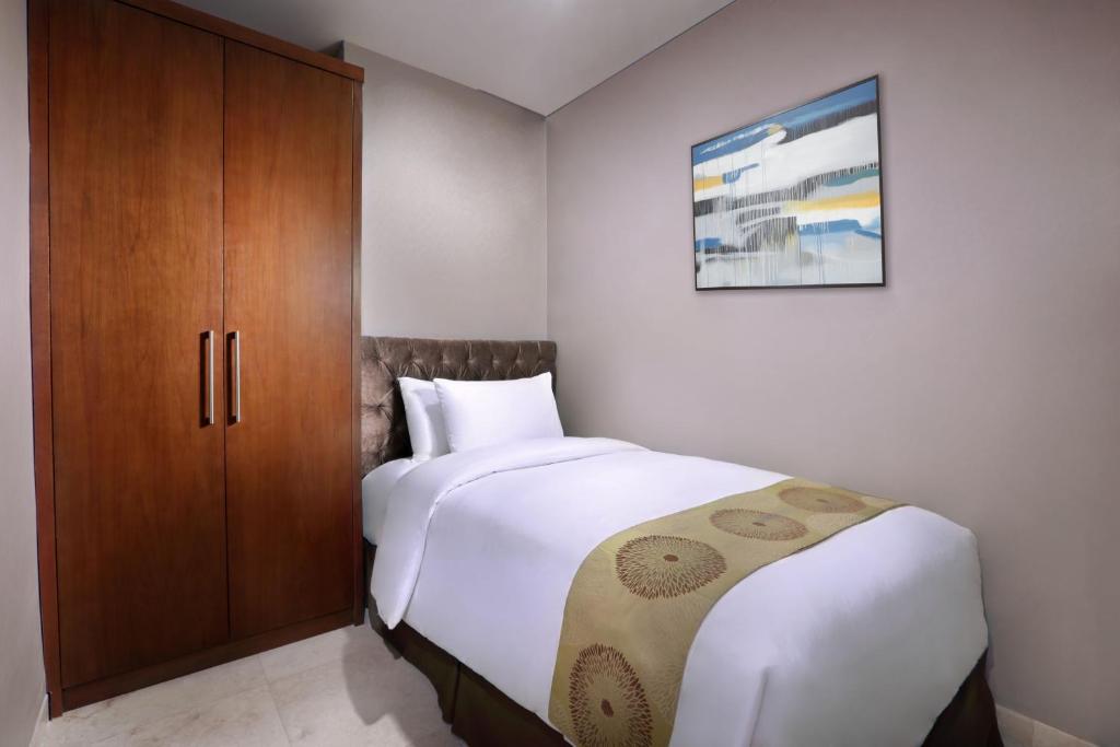 Postel nebo postele na pokoji v ubytování The Grove Suites by Grand Aston