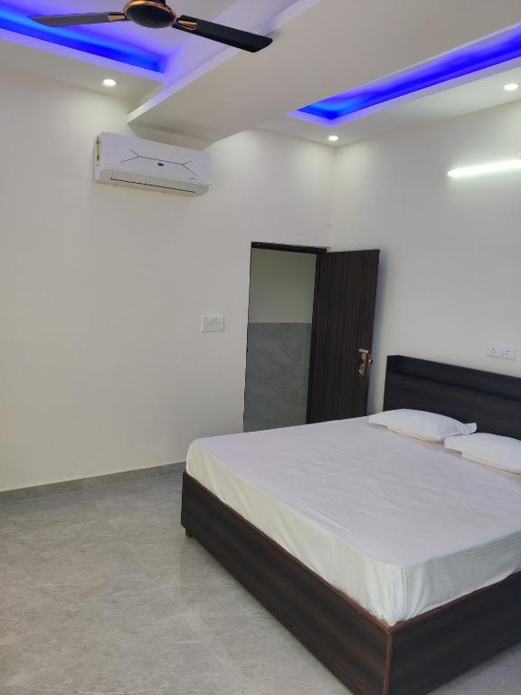 a bedroom with a bed with a blue ceiling at Heaven Heights in Rājpur