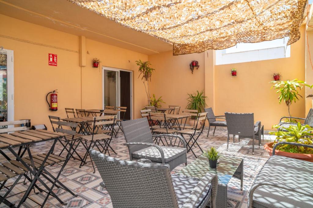a patio with tables and chairs in a restaurant at Ella Torremolinos Centro in Torremolinos