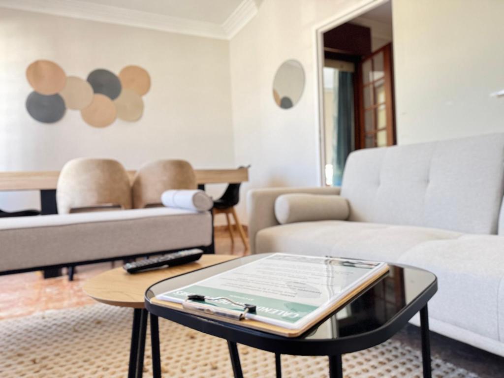 a living room with a couch and a table at La Maison Du Belvedere in Saint-Cyprien
