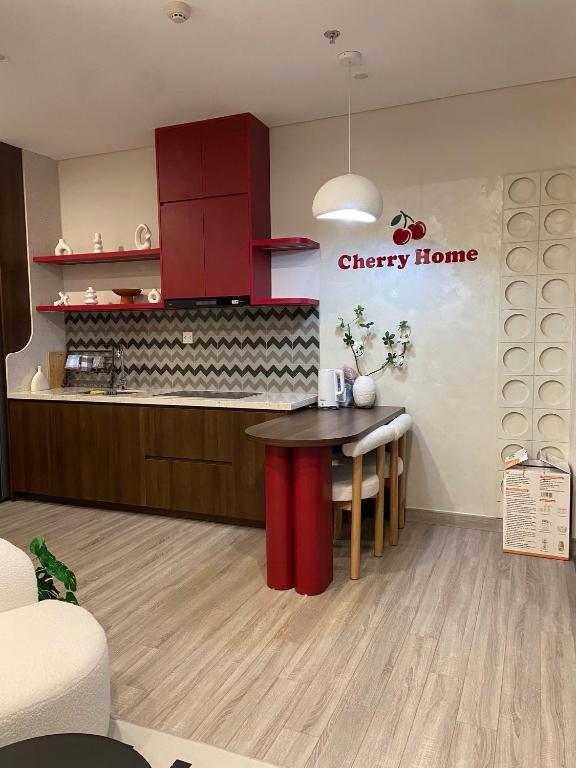 a kitchen with a cherry home sign on the wall at Cherry Home in Ðan Phô