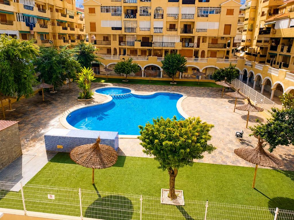an overhead view of a swimming pool in a building at ESTUDIO Torrevieja P & A - Piscina y Playa La Mata 3 min in La Mata