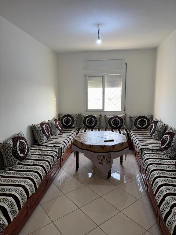 a living room with a couch and a table at RiF Services in Al Hoceïma