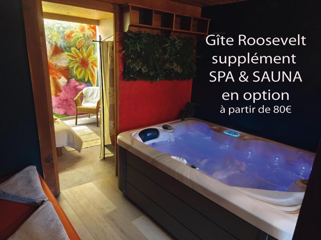 a bath tub in a room with a painting at 3 Gites- Le Roosevelt, Côte 204, Côte 204 Bis in Château-Thierry