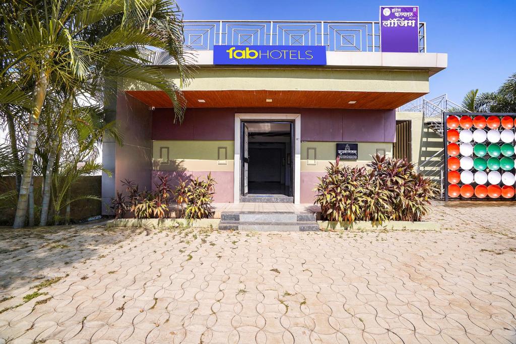a building with a door and a sign on it at FabHotel Kalptaru in Pune