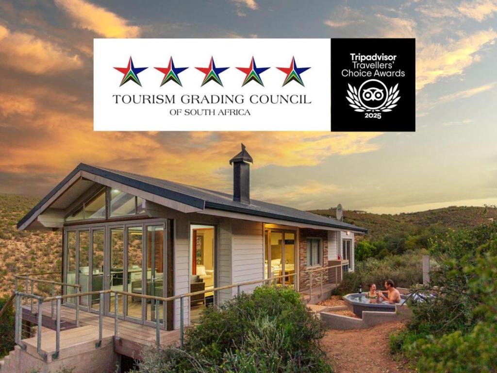a house with a sign that reads tourism gardening council at Landrani Luxury Lodge in Oudtshoorn