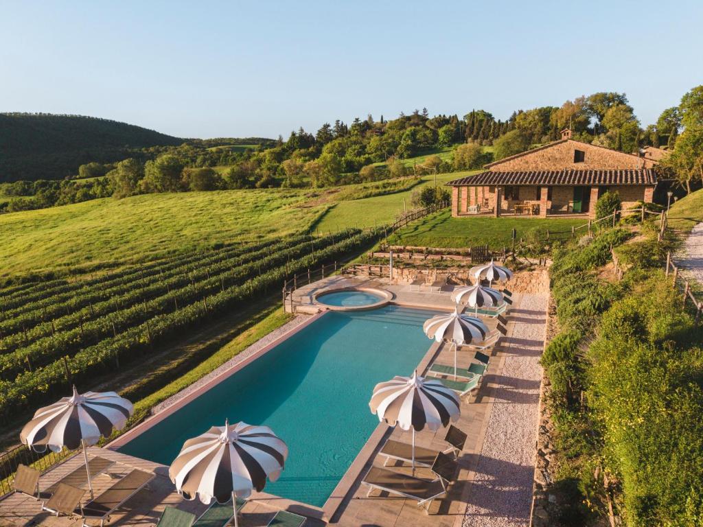 an aerial view of a pool with umbrellas at Tuscan Relais Il Serraglio in Montepulciano