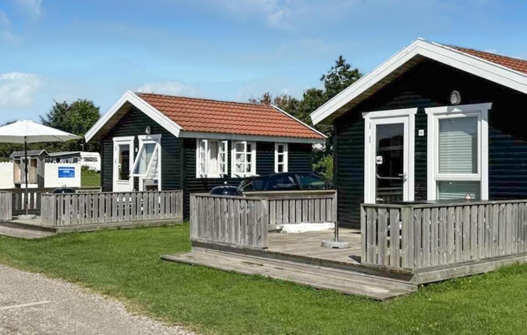 a house with a wooden fence in front of it at Beautiful Apartment In Farsø in Farsø