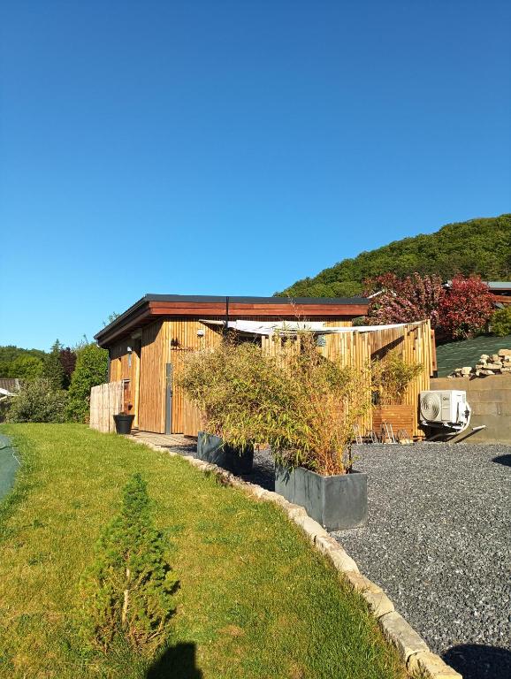 a house with a yard next to a building at Résidence des Sapins in Liverdun