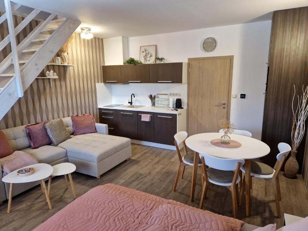 a living room with a couch and a table at Apartmán Sophia 6 in Velké Losiny