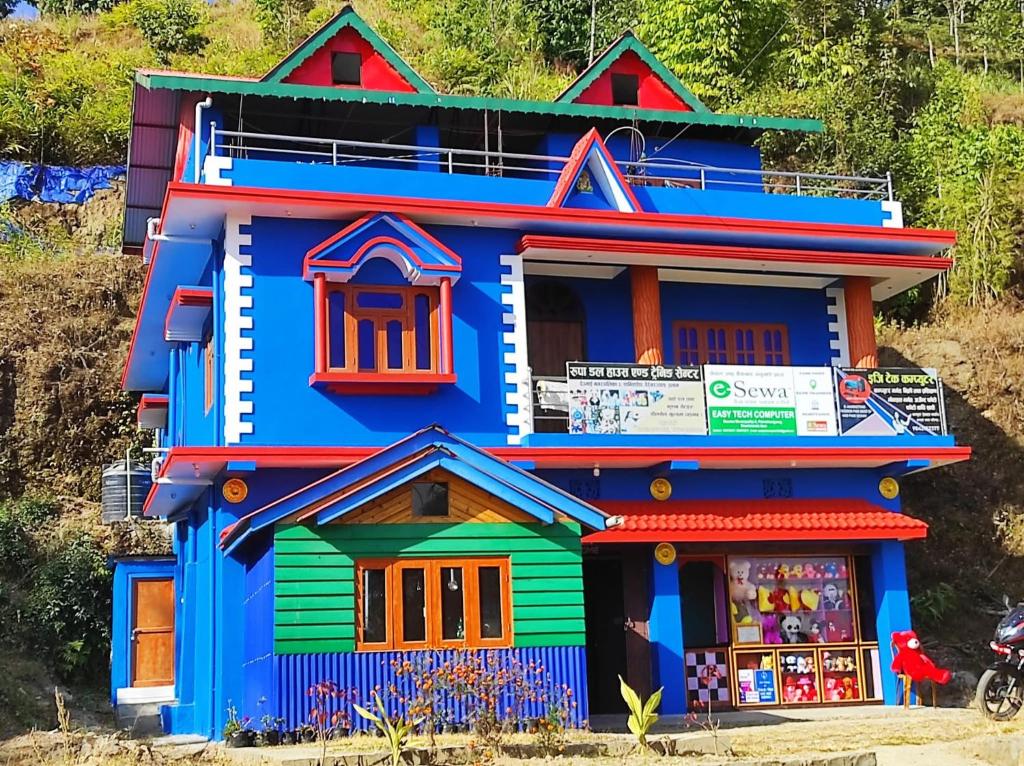 a colorful house with a store in front of it at Deumai Homestay in Ilām