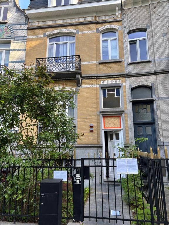a building with a fence in front of it at partie jasmin in Brussels