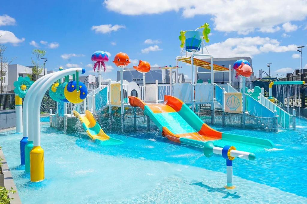 a water park with slides in the water at Your Happy Place in Batulao Artscapes - 2Br near Twin Lakes Tagaytay in Calo