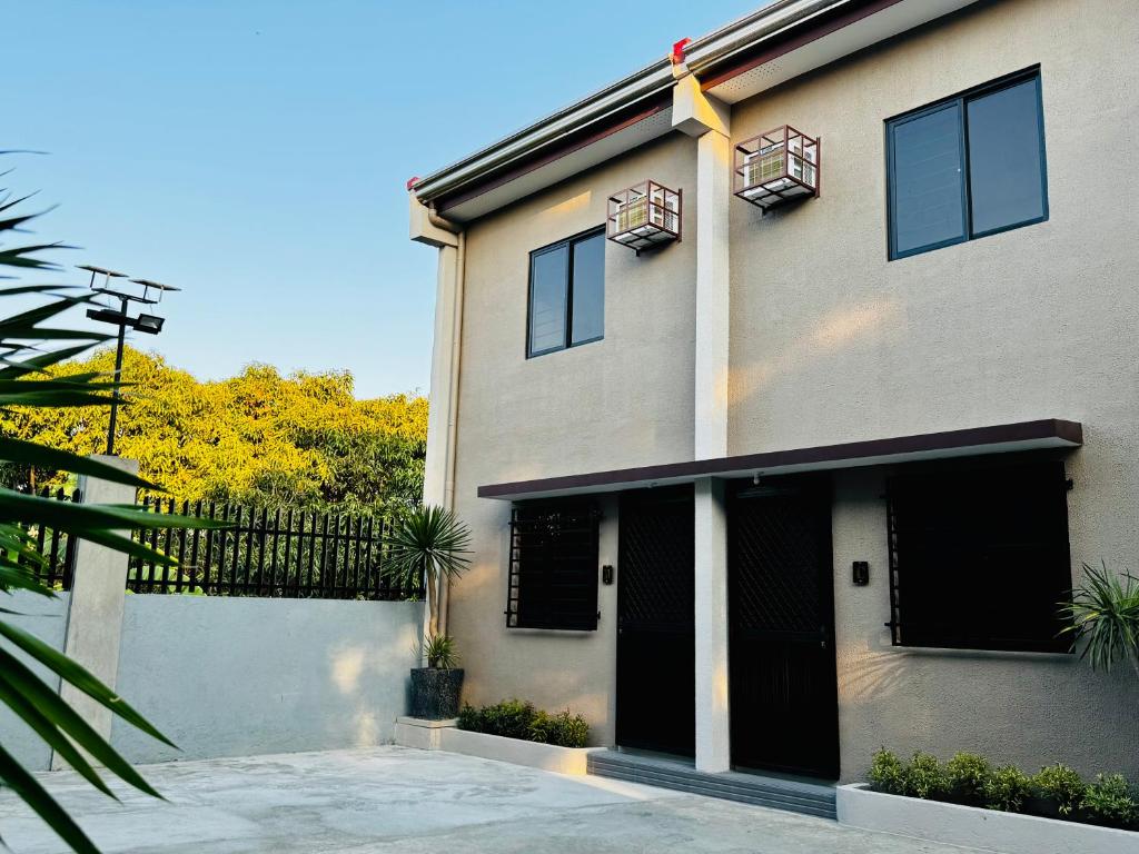 a building with black doors and a fence at Sebastians CRIB D in Dasmariñas