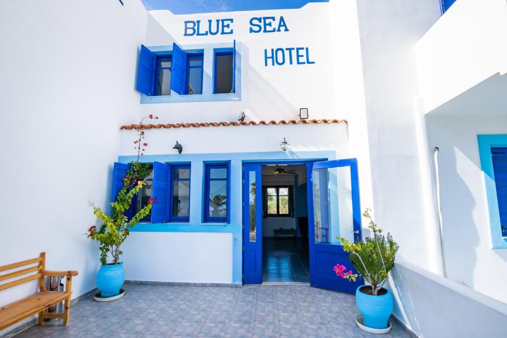 a blue and white building with a blue sea hotel at Blue Sea Hotel in Amoopi