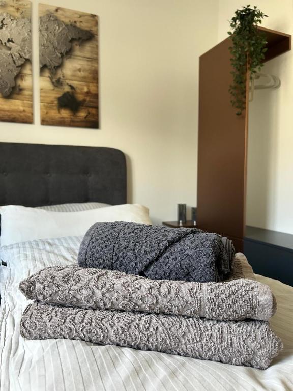 a pile of blankets sitting on top of a bed at Aaberg Lounge in Waldshut-Tiengen