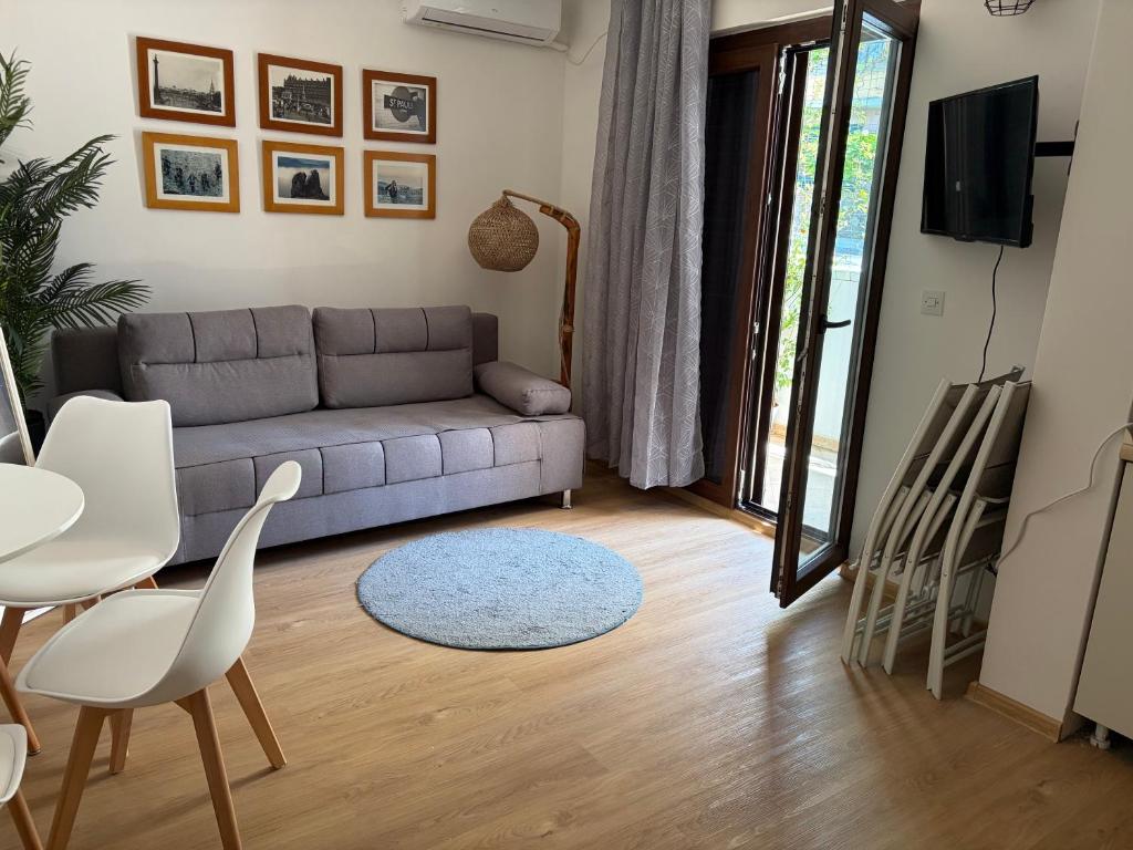 a living room with a couch and a table at Apartman Biljana in Rafailovici