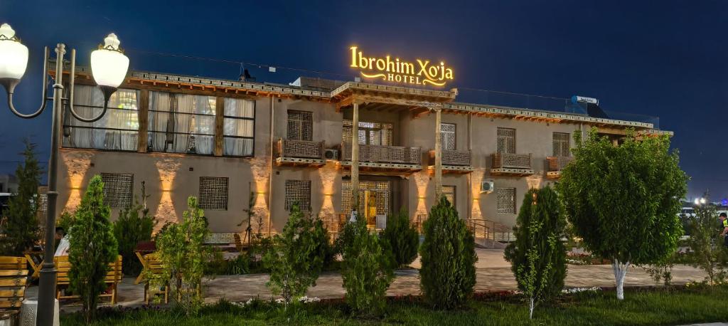 a building with a sign on top of it at Ibrohim Xoja Hotel in Khiva