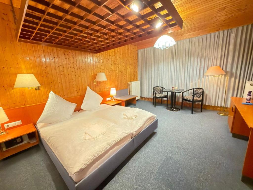a bedroom with a bed and a table and chairs at RS Aparthotel in Schöppenstedt
