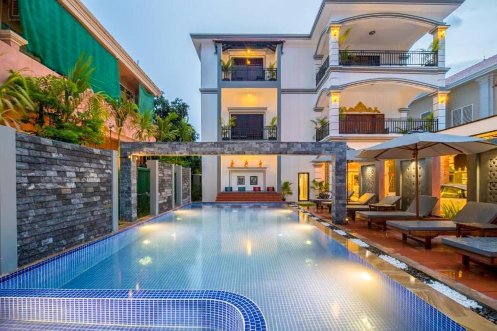 a swimming pool in front of a house at Sakun House in Siem Reap