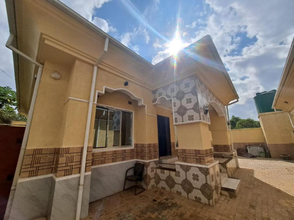 a building with the sun shining on the side of it at Golden View Guest House in Lilongwe