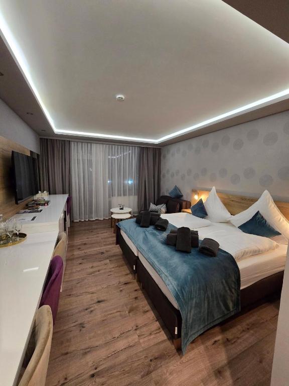 a large hotel room with two beds and a desk at TeMax Lux Hahnenklee in Goslar