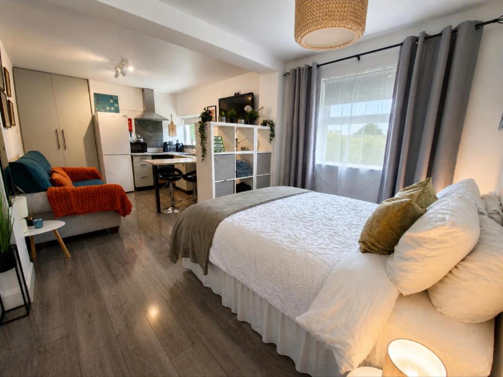 a bedroom with a bed and a living room at The Éire Escape Countryside Studio near Newgrange & Dublin in Slane