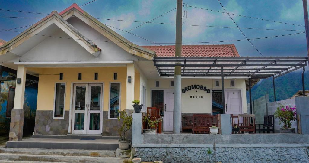 a small house with a pergola in front of it at BROMO B&B in Bromo