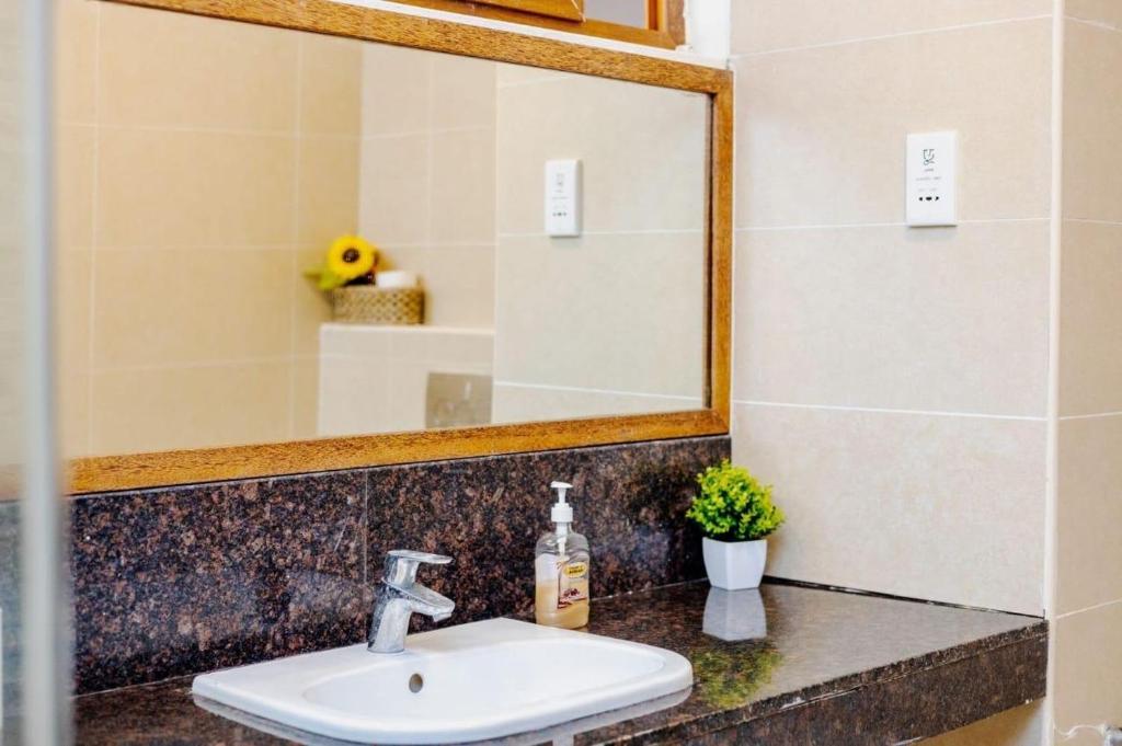 a bathroom with a sink and a mirror at Diani dreams Villa in Ukunda