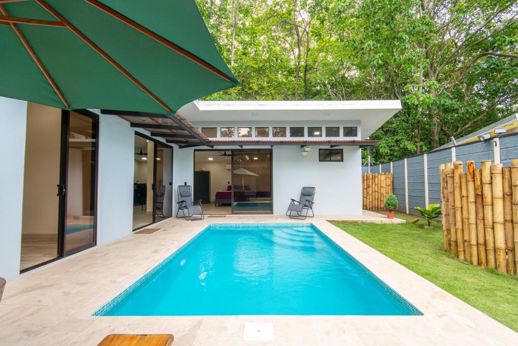 a swimming pool in the backyard of a house at Villa Libe Puerto Viejo in Puerto Viejo