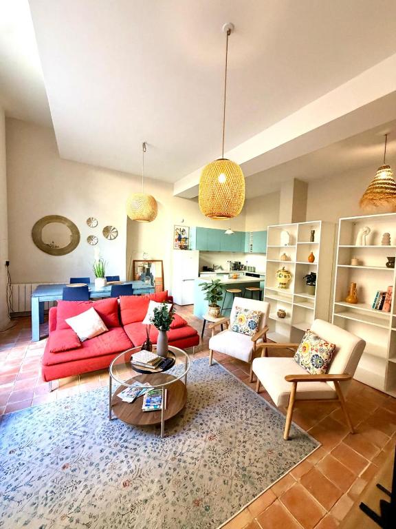 a living room with a red couch and chairs at T2 monument historique Aix en provence in Aix-en-Provence