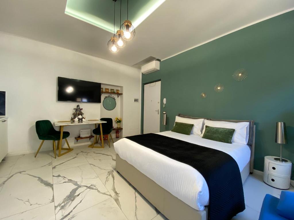 a bedroom with a bed and a table and a desk at Leo&Franci Loft in Legnano