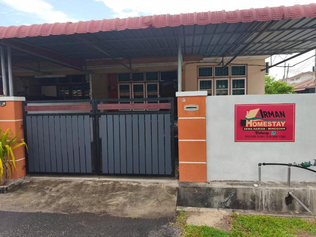 a building with a gate and a sign on it at Irman Homestay Pendang in Pendang