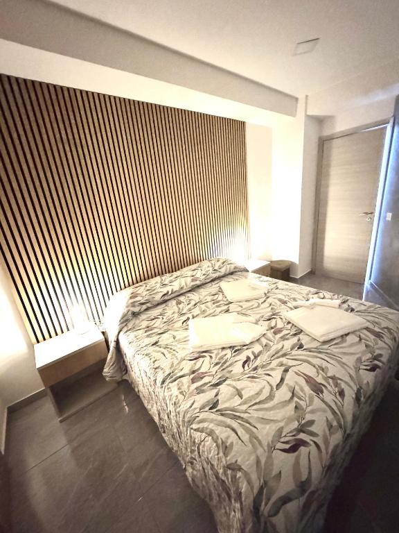 a bedroom with a bed with two pillows on it at Ali apartments in Pizzo