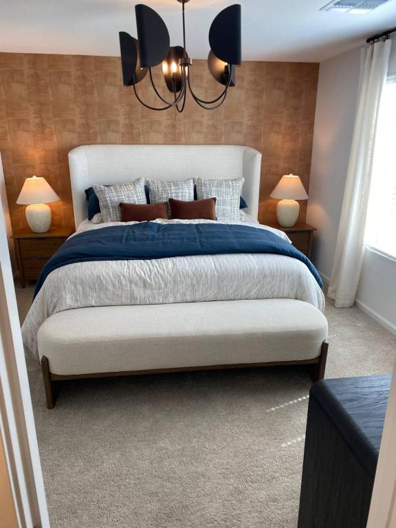 a bedroom with a large bed and two lamps at Todd's Relaxation Place in Maricopa