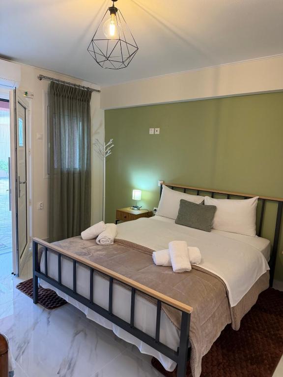 a bedroom with a large bed with two towels on it at Flo's Apartments in Missolonghi