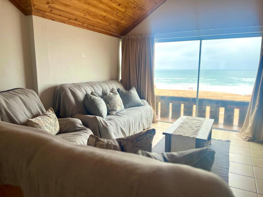 a living room with two couches and a large window at Seaview at it’s best in Hentiesbaai