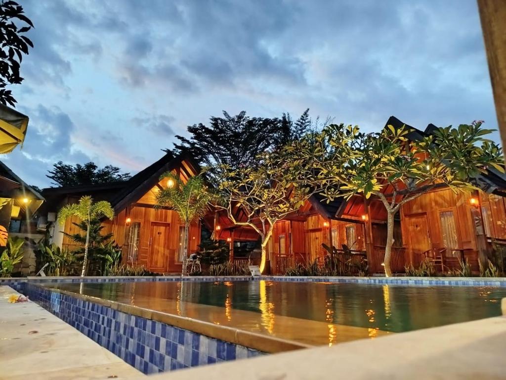 an image of a house with a swimming pool at Villa GHANIA in Labuanbalat