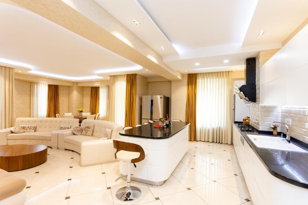 a large living room with a couch and a table at Cityscape Luxury Apartment in Tbilisi City