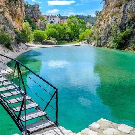 a bridge over a river with green water at Quesa Tranquil Valencia in Quesa