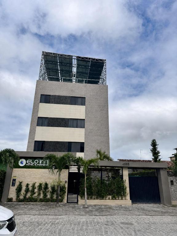 a tall building with a large building at Pousada Elo Inn in Recife