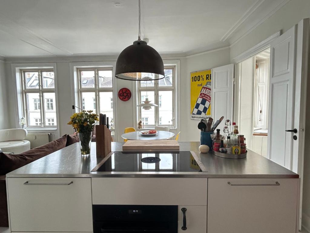 a kitchen with a sink and a counter top at Bright apartment in central Copenhagen in Copenhagen