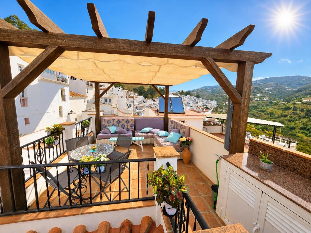 a balcony with a view of a city at Casa mi sùeño azul in Torrox