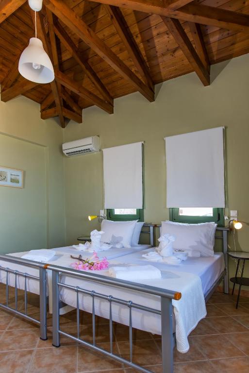 a bedroom with a large bed with flowers on it at Eltheo Villas in Agios Nikitas