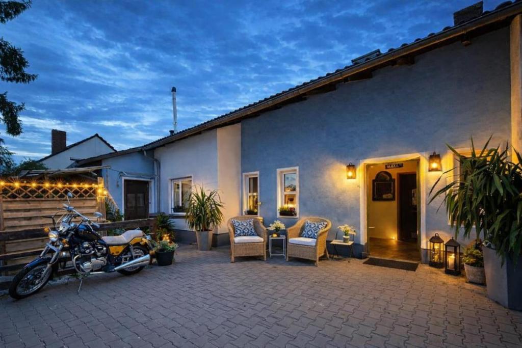 a motorcycle parked on a patio next to a house at Gästehaus Möbius in Markt Erlbach