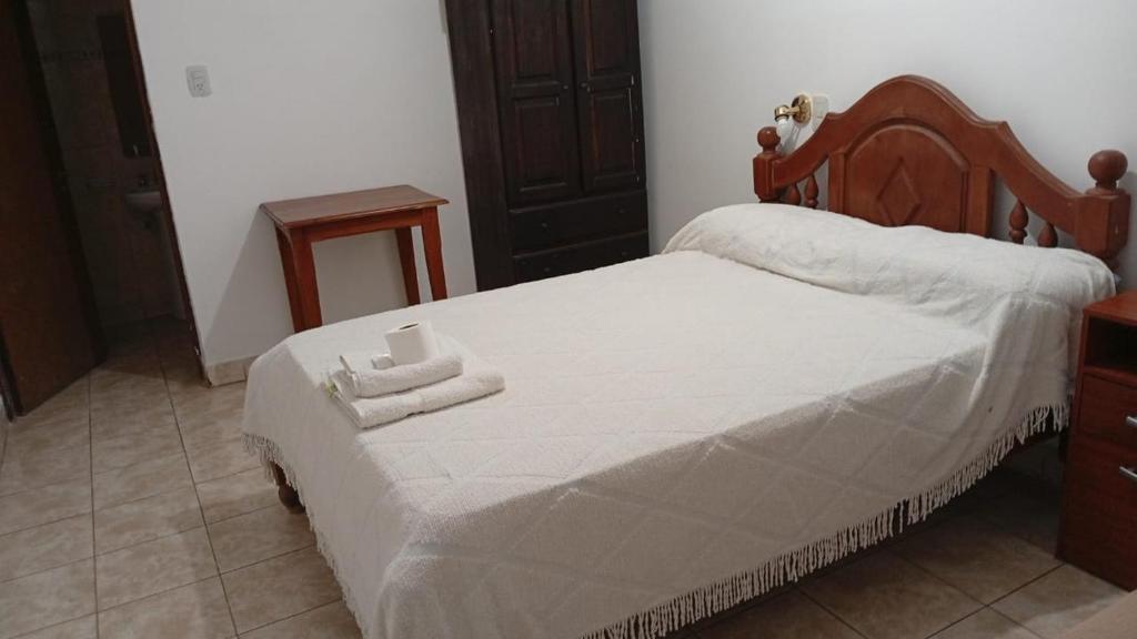a bedroom with a bed with two towels on it at Ragas in Palma Sola