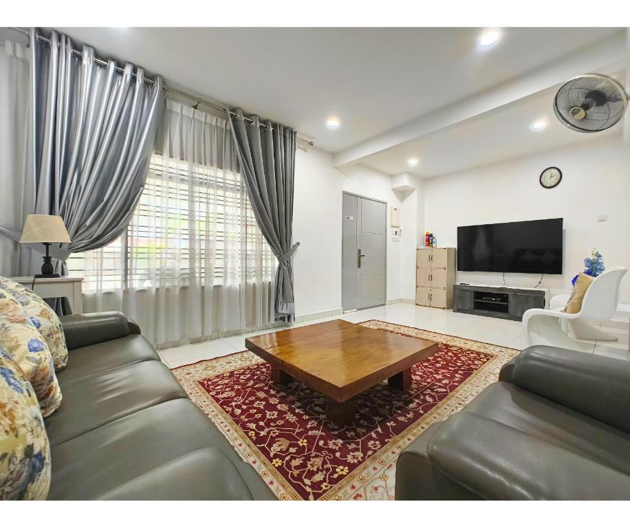 a living room with a couch and a coffee table at 61 StayAtHome in Nibung Tebal